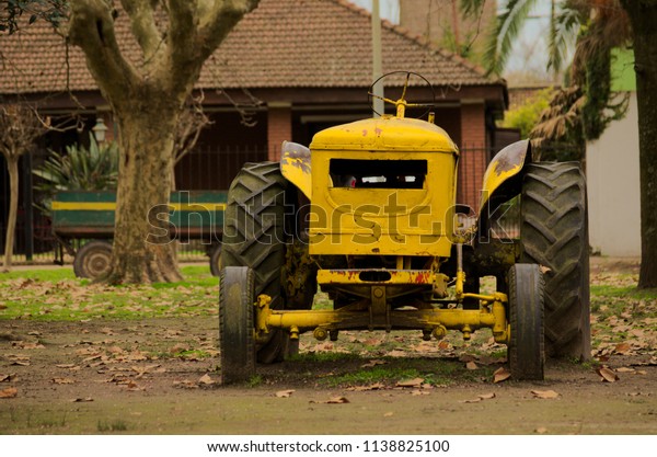 Old field\
tractor out of service in a\
square