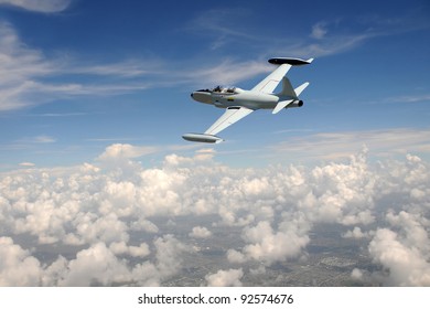 Old Fighter Jet Soaring Above The Clouds