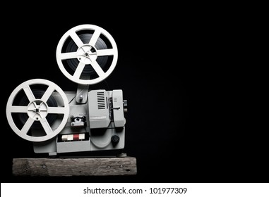 Old Film Projector On A Black Backgroun