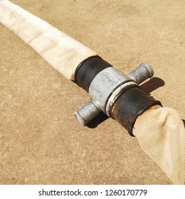 An Old Fire Hose On The Ground. Fire Fighting Concept Image. 