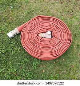 An Old Fire Hose On The Ground. Fire Fighting Concept Image. 