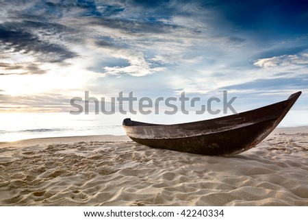 Old fisherman boat at sunrise time on the beach