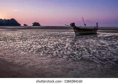 Old Fishing boats at low tide at dusk or twilight at low tide on the sand Nai Yang Beach Phuket Thailand - Shutterstock ID 1384384160