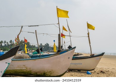 old fishing boats in sand on ocean in India on blue sky background - Powered by Shutterstock