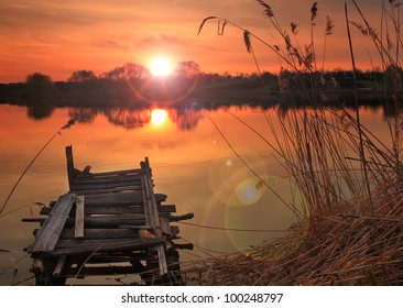 Old fishing bridge on the lake at sunset - Powered by Shutterstock