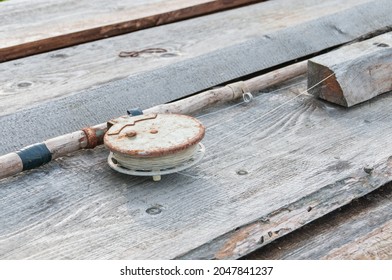 Old fishing rod with a round reel, side view - Powered by Shutterstock