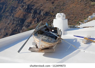 Old fishing row boat on the roof in Fira, Santorini island, Greere