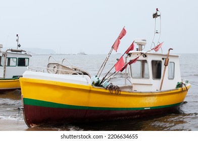 An Old Fishing Schooner Is Parked On The Shore Of The Sea