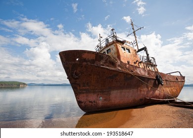 Old fishing vessel on the sea coast in sunny day. - Powered by Shutterstock