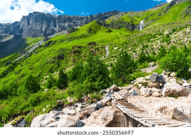 An old, flimsy wooden bridge across a turbulent, full-flowing mountain river with a fast current. Caucasus, Elbrus region. - Powered by Shutterstock