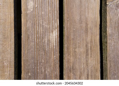 Old Floorboards Of A Wooden Pier Stained With Sand