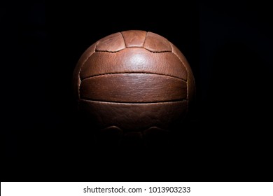 Old Football Leather Ball On A Black Background