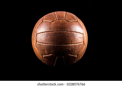 Old Football Leather Ball On A Black Background