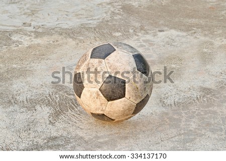 Old football on concrete background