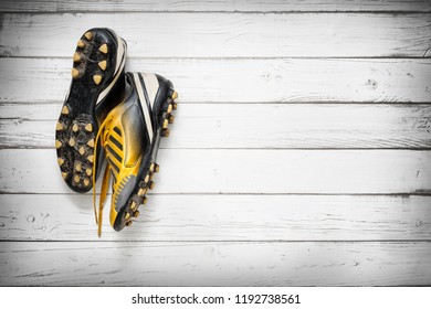 Old Football Shoes Hanging On Wooden Wall