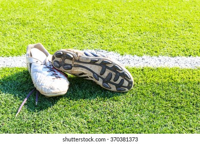 Old Football Shoes On Green Grass