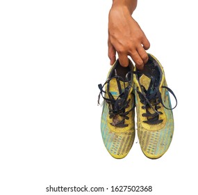 Old Football Soccer Player Holding Football Boots Cleats In Hand On White Background With Copy Space.