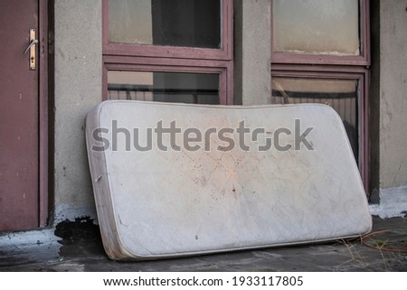 Similar – Image, Stock Photo Discarded mattress on the sidewalk in the light of a street lamp in front of an anonymous hotel façade