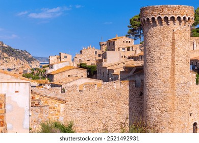 Old fortified wall, towers and stone houses inside in Tossa de Mar, Catalonia, Spain - Powered by Shutterstock