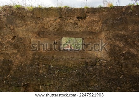 old fortifield wall small part of it with arrowslit and embrasure