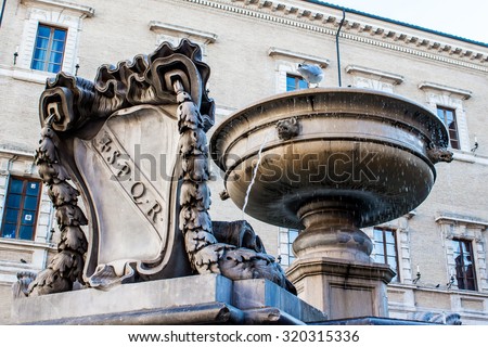 Old fountain with the coat of arms of ancient Rome, SPQR carved in marble, in Rome, Italy