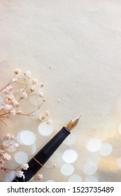 Old Fountain Pen, On Aged Paper, With Flowers And Bokeh; Background With Copy Space