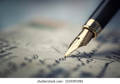 Old fountain pen on an vintage handwritten letter. Conceptual background on history, education, literature topics. Retro style.