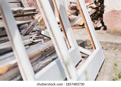 Old Frames And Shutters From Old Dismantled Doors And Windows Lie In The School Yard For Transportation For Recycling. Selective Focus