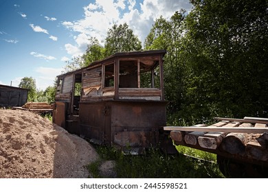 Old freight car for clearing the snow of narrow-gauge railways on the background of nature. Retro technology rusted and abandoned