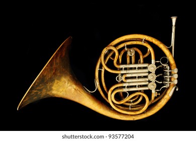 Old French Horn Isolated On The Black Background