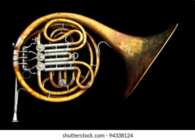 Old French Horn Isolated On The Black Background