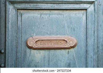 Old french letter box on blue wood door - Powered by Shutterstock