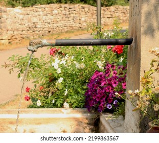 Old French Village Fountain With Water Spitting Fish