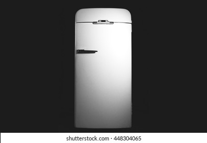 Old fridge isolated on black background