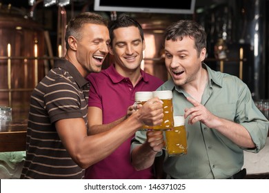 Old Friends. Three Happy Friends Drinking Beer At The Pub