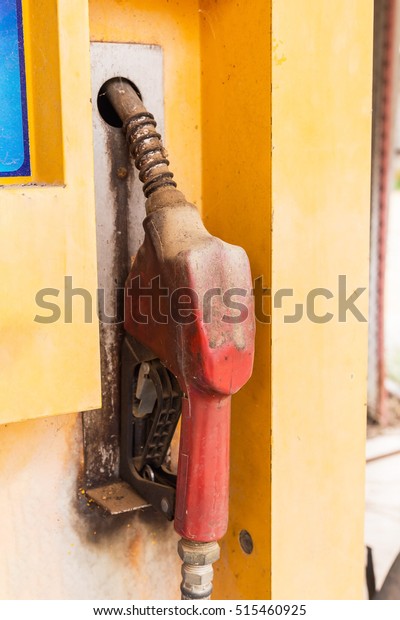 The old Fuel nozzle, the old Gas pump nozzles in\
a service station.