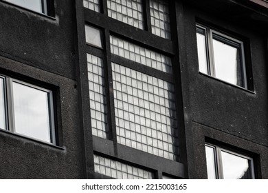 Old Functionalist House Facade In Prague With Windows And Glass Tiles In Stairway Part Of The Building. Black And White Shot. Rough Facade. 