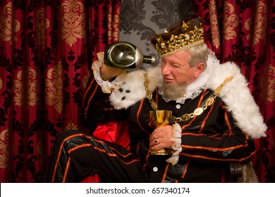 Old Funny King Getting Drunk Holding A Golden Goblet