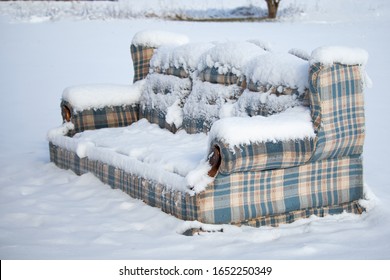 Old Furniture Left Outside In The Snow