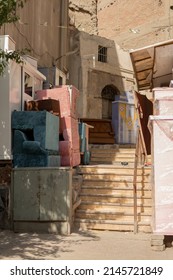 Old Furniture Trash Stacked On Side Of Steps In Narrow Corridor Between Houses In Cairo Street Captured On Sunny Day In Egypt 