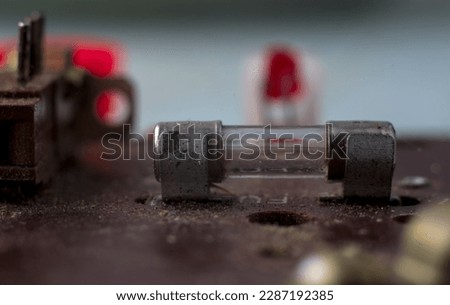 Old fuse on the circuit board close-up