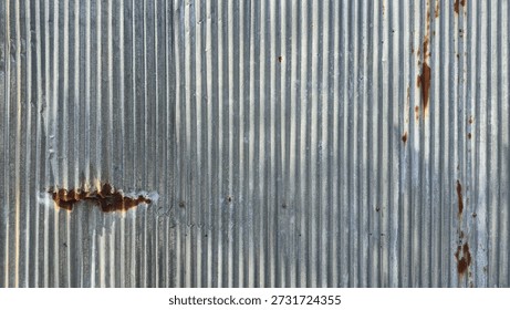 Old galvanized sheet wall with rust background. Rusted galvanized iron plate, red stain on old metal sheet wall texture. Vintage-style metal sheet fence texture.