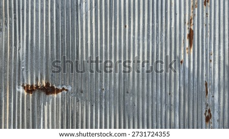 Old galvanized sheet wall with rust background. Rusted galvanized iron plate, red stain on old metal sheet wall texture. Vintage-style metal sheet fence texture.