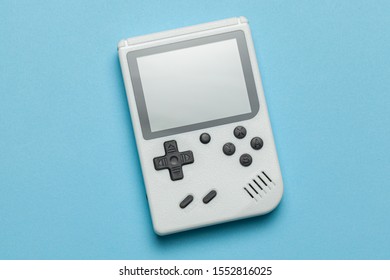 Old Game Console. Gamepad Is White On Blue Background. Copy Space For Text.