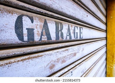 Old Garage Sign At A Gate - Photo