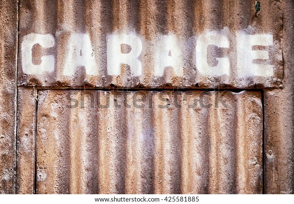 old garage sign at a\
wall