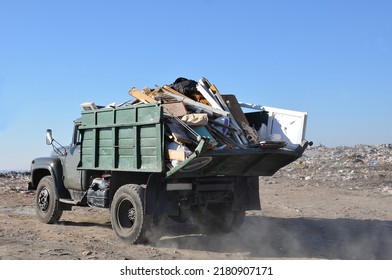 Old Garbage Track Carrying Broken Furniture And Construction Trash On The Municipal Landfill