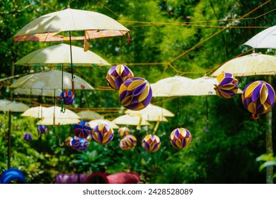 the old garden is decorated with hanging umbrellas and honeycomb paper ball - Powered by Shutterstock