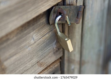 Old Garden Shed Door With Open Padlock 