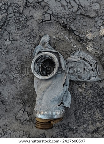 Old gas mask with cracked glass in an abandoned building. Chemical Gasmask without filter. 